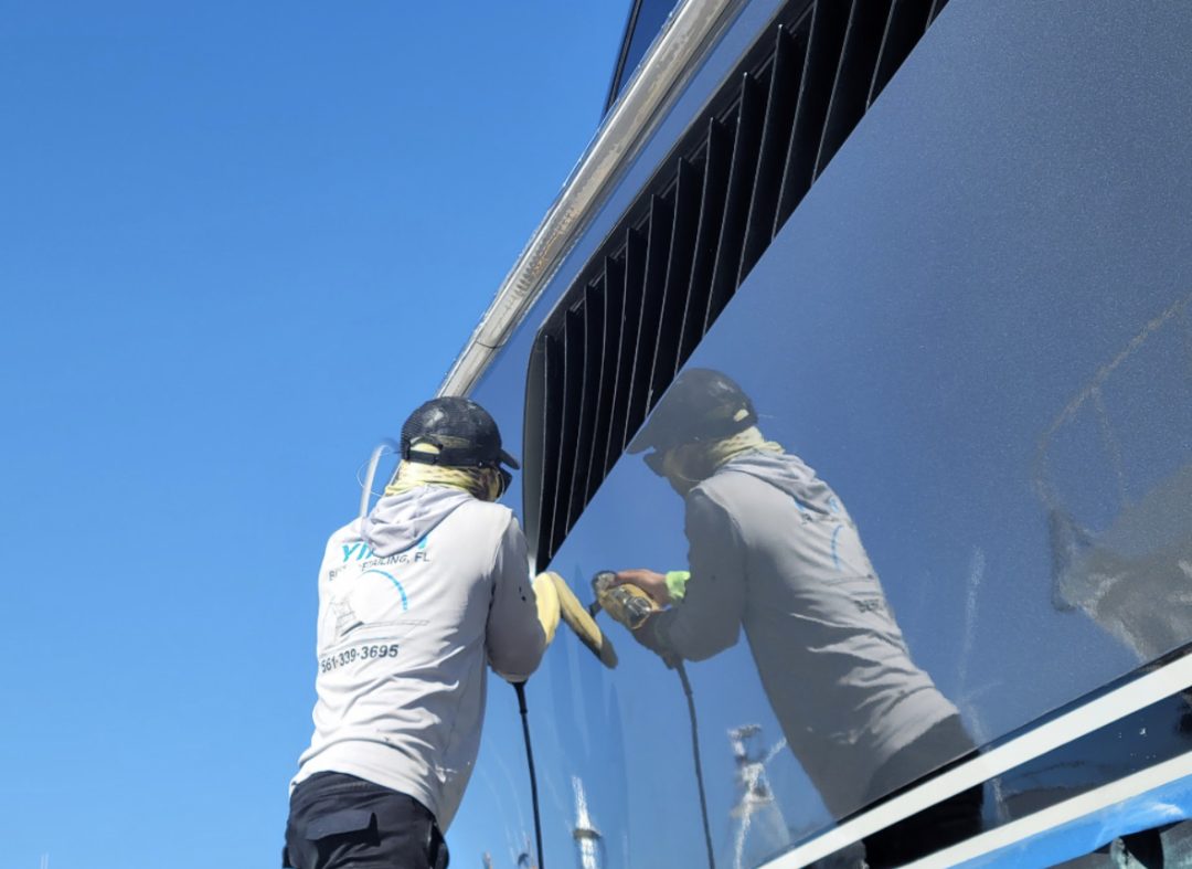 A man scrubs the surface of a boat, ensuring it is clean and well-maintained for future use.